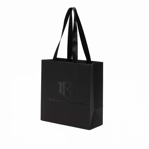 Scratch resistant black paper bag with glossy UV logo and satin ribbon handles for luxury boutique packaging