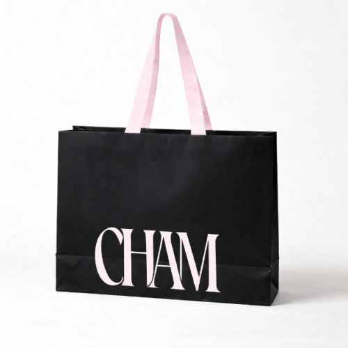 Custom branded black paper shopping bag with pink logo and grosgrain ribbon handles