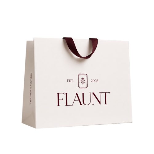 Custom ivory boutique retail paper bag with burgundy logo and grosgrain ribbon handles